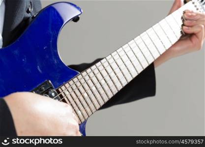 Man playing guitar. Close up of male hands playing electric guitar