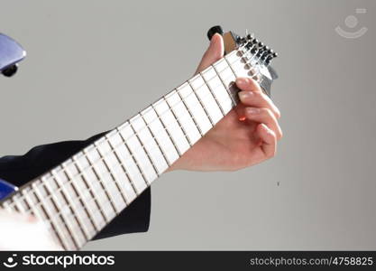 Man playing guitar. Close up of male hands playing electric guitar