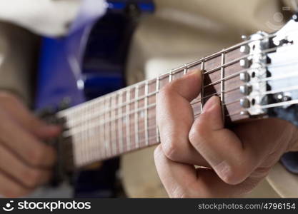 Man playing guitar. Close up of male hands playing electric guitar