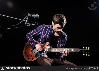 Man playing guitar during concert