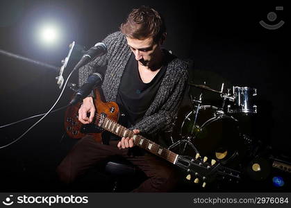 Man playing guitar during concert