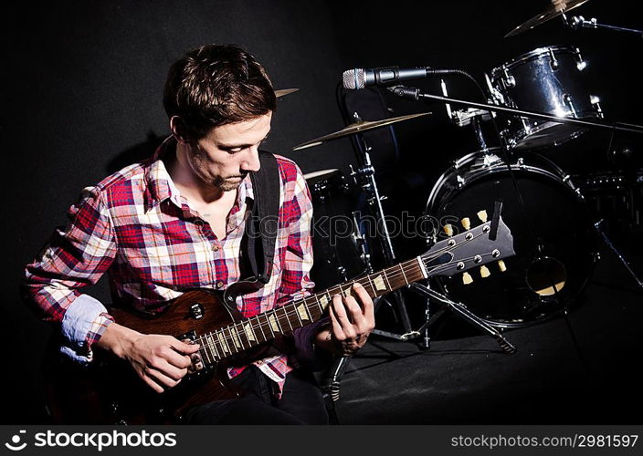 Man playing guitar during concert