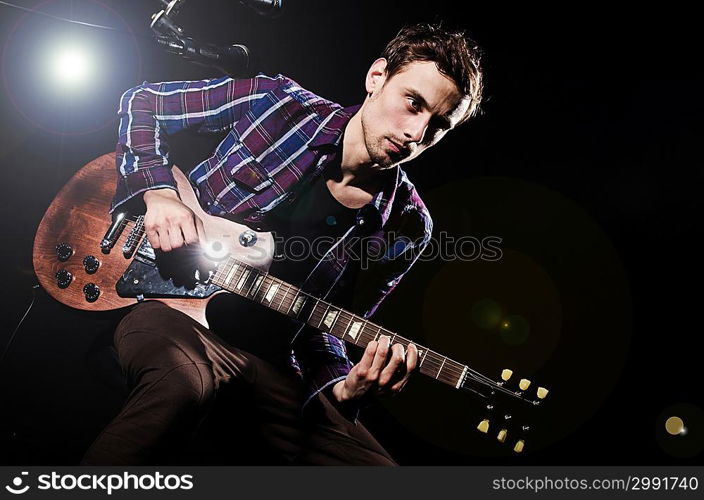 Man playing guitar during concert