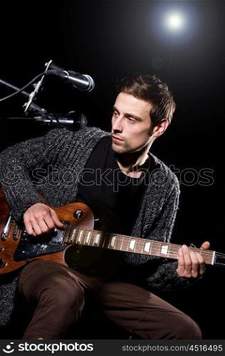 Man playing guitar during concert