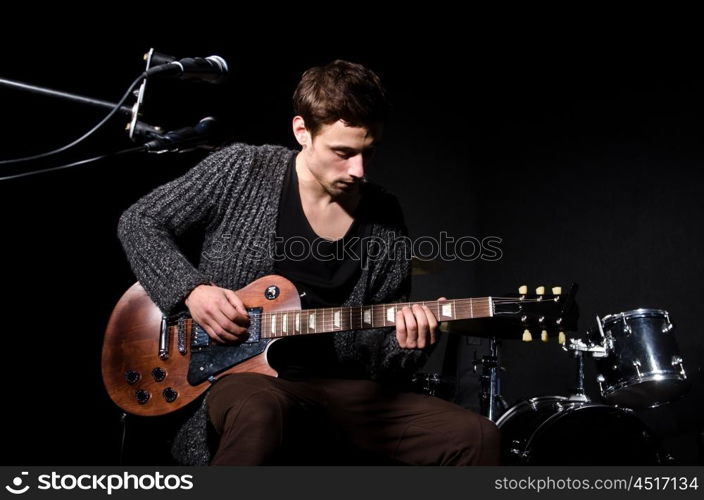 Man playing guitar during concert