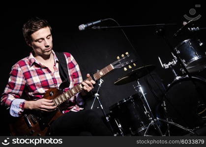 Man playing guitar during concert