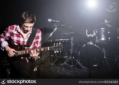 Man playing guitar during concert