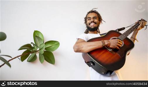 man playing guitar with copy space