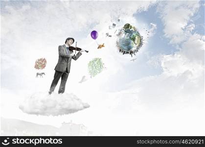 Man playing holiday melody. Funny man in hat playing violin presenting celebration concept. Elements of this image are furnished by NASA