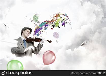 Man playing holiday melody. Funny man in hat playing violin presenting celebration concept