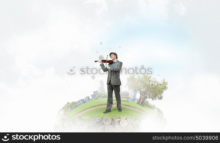 Man playing holiday melody. Funny man in hat playing violin presenting celebration concept