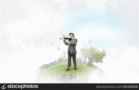 Man playing holiday melody. Funny man in hat playing violin presenting celebration concept