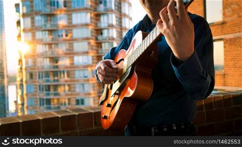 Man Playing Jazz Guitar on Balcony during Sunset