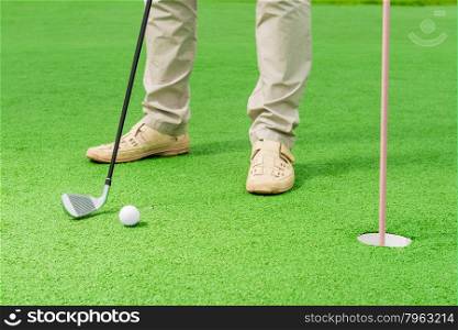 man playing of golf in the frame only the legs
