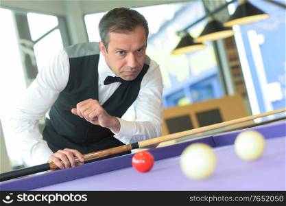 man playing pool in a bar
