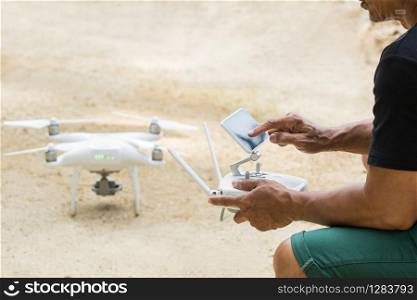 man playing quad copter drone for taking aerial photography