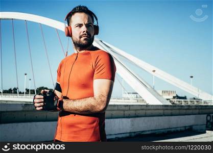 man playing sports and listening to music with headphones