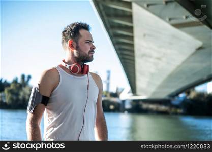 man playing sports and listening to music with headphones