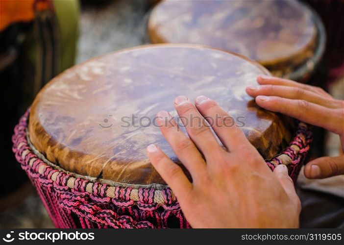 Man playing the djembe (african drum) outdoors