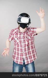 Man playing video game wearing virtual reality device. Gaming equipment for gamers concept.. Gamer man wearing VR