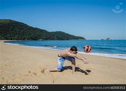 man playing volleyball shoreline