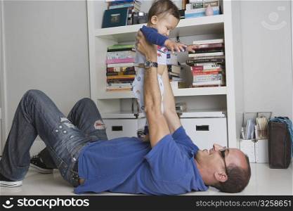 Man playing with baby boy