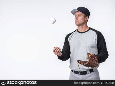 man playing with baseball holding glove