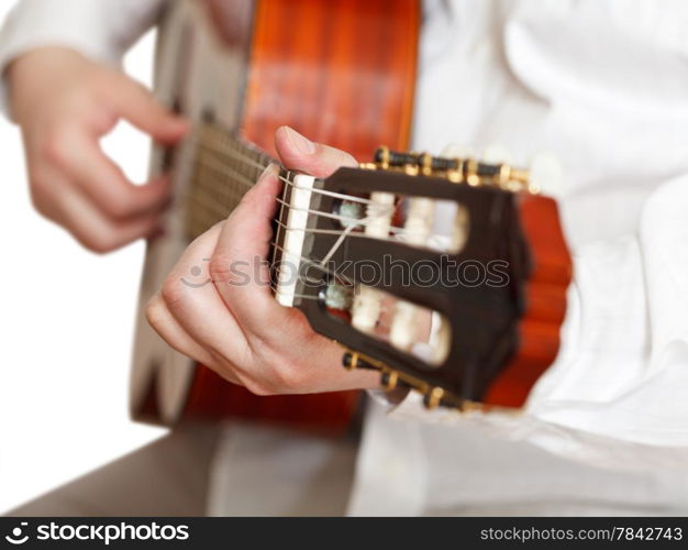 man plays on classical acoustic guitar close up isolated on white background