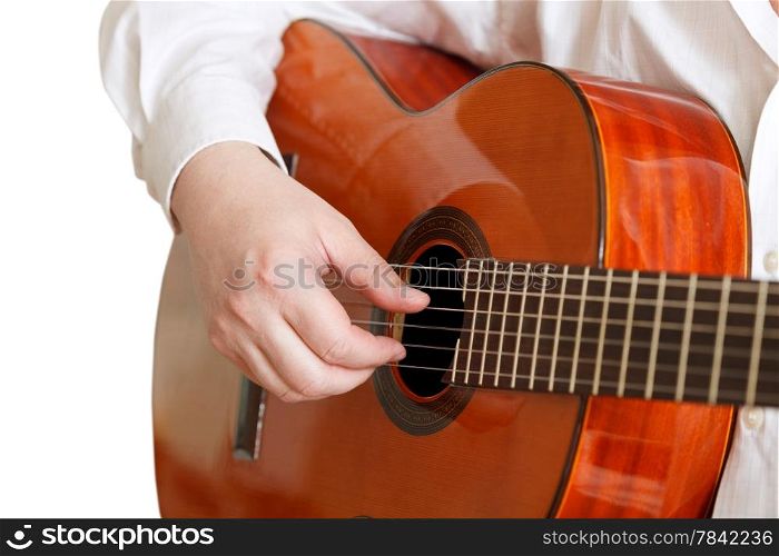 man plays on typical acoustic guitar close up isolated on white background