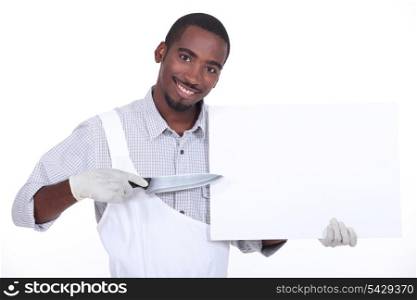 Man pointing a knife at a board left blank for your message