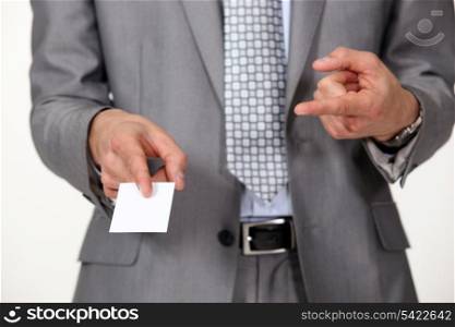 Man pointing at business card