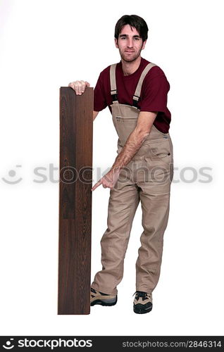 Man pointing at plank of laminate flooring