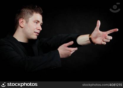 man pointing at something interesting showing your product black background