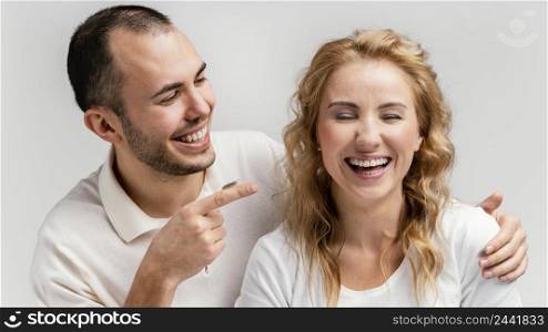 man pointing woman laughing