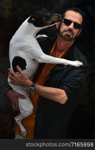 man posing with his dog in his arms