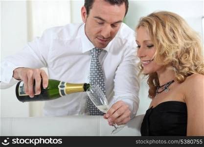Man pouring glass of champagne