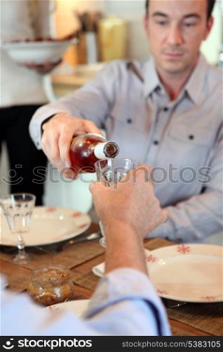 Man pouring wine during meal