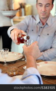 Man pouring wine during meal