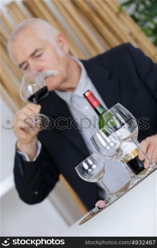 man pours a glass of wine