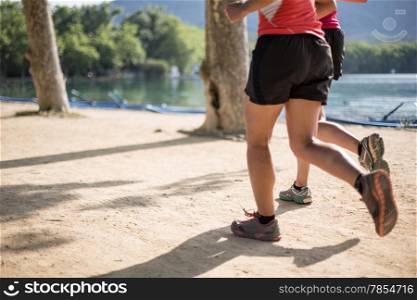 Man practicing the sport of athletics beside a lake