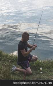 Man prepare rod for fishing. Mountain lake. Bulgaria