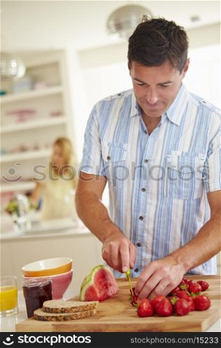 Man Preparing Healthy Breakfast In Kitchen