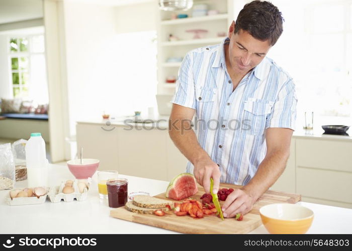 Man Preparing Healthy Breakfast In Kitchen