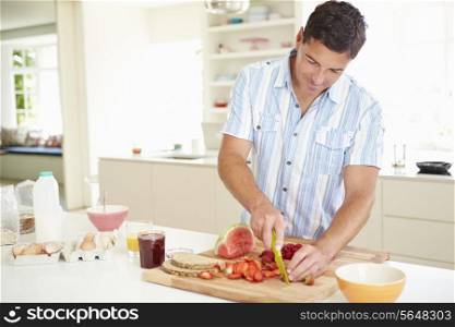 Man Preparing Healthy Breakfast In Kitchen