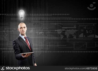 Man presenting tablet pc. Young bald businessman with tablet pc against digital background