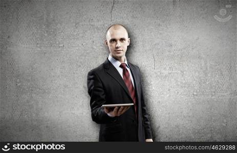Man presenting tablet pc. Young businessman holding in hand tablet pc
