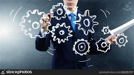 Man presenting teamwork concept. Close view of businessman drawing teamwork concept on screen