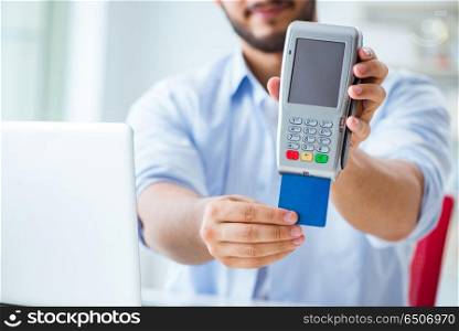 Man processing credit card transaction with POS terminal