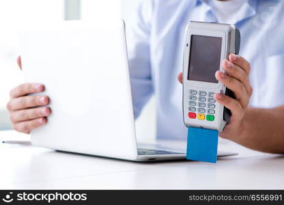 Man processing credit card transaction with POS terminal