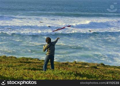 Man propels model plane from Lisbon coast